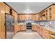 Bright and modern kitchen featuring stainless steel appliances, custom wood cabinets, and sleek countertops at 3539 W Davidson Ln, Phoenix, AZ 85051