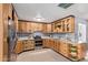 Functional kitchen with stainless steel appliances, wood cabinetry, and ample counter space for cooking at 3539 W Davidson Ln, Phoenix, AZ 85051