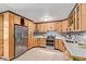 Well-equipped kitchen with stainless steel appliances, custom cabinets, and bright countertops at 3539 W Davidson Ln, Phoenix, AZ 85051