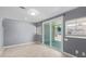 Modern living room with tile floors, sliding glass doors, and neutral paint for a versatile design at 3539 W Davidson Ln, Phoenix, AZ 85051
