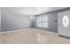 Bright, minimalist living room with tile flooring, fresh paint, and a window with natural light at 3539 W Davidson Ln, Phoenix, AZ 85051