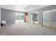 Spacious bedroom with carpeting, built-in storage, and sliding glass doors to the outdoor area at 3539 W Davidson Ln, Phoenix, AZ 85051