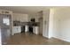 Open-concept kitchen with white cabinets, stainless steel appliances, and ample countertop space at 4217 W Medlock Dr, Phoenix, AZ 85019
