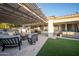 Spacious backyard patio with a hot tub, outdoor kitchen, and covered seating area, perfect for relaxing or entertaining at 4636 E Carriage Ct, Gilbert, AZ 85297
