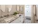 Bright bathroom features a double sink vanity with granite countertop and a separate shower and bathtub at 4636 E Carriage Ct, Gilbert, AZ 85297