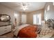 Cozy bedroom featuring a decorative metal bed frame, soft lighting, and a full bathroom view at 4636 E Carriage Ct, Gilbert, AZ 85297