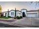 Beautiful single-story home with well-manicured landscaping, and a three-car garage at 4636 E Carriage Ct, Gilbert, AZ 85297