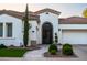 Close-up of the front entrance with a decorative wrought iron door and manicured landscaping at 4636 E Carriage Ct, Gilbert, AZ 85297