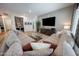 Spacious living room featuring a large sectional sofa, mounted TV, and modern decor at 4636 E Carriage Ct, Gilbert, AZ 85297