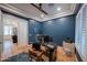 Stylish office with blue walls, hardwood floors, and a modern desk setup perfect for productivity and focus at 4636 E Carriage Ct, Gilbert, AZ 85297