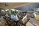 Outdoor living area under a pergola, with a dining table, built-in grill, and comfortable lounge seating at 4636 E Carriage Ct, Gilbert, AZ 85297