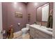 Stylish powder room with modern vanity, gold fixtures, decorative mirror, and elegant wall decor at 4636 E Carriage Ct, Gilbert, AZ 85297