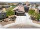 Aerial view of a home with a tile roof, three-car garage, and desert landscaping at 4654 W Suncup Dr, San Tan Valley, AZ 85144
