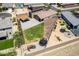 Spacious backyard featuring a covered patio, green grass, playground and trampoline for Gathering fun at 4654 W Suncup Dr, San Tan Valley, AZ 85144