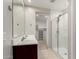 Bathroom featuring dual sinks, glass enclosed shower and walk-in closet at 4654 W Suncup Dr, San Tan Valley, AZ 85144