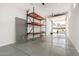 Well-lit garage with epoxy flooring and a workbench for projects at 4654 W Suncup Dr, San Tan Valley, AZ 85144