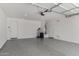 Spacious garage with epoxy flooring, ample lighting, and storage areas at 4654 W Suncup Dr, San Tan Valley, AZ 85144