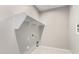 Functional laundry room with white shelving for ample storage space at 4654 W Suncup Dr, San Tan Valley, AZ 85144