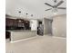 Open-concept kitchen and living space features stainless steel appliances and tile flooring at 4654 W Suncup Dr, San Tan Valley, AZ 85144