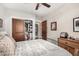 Bedroom features closet, ceiling fan, dresser, and hardwood floors for a comfortable space at 4909 N Woodmere Fairway -- # 1004, Scottsdale, AZ 85251