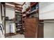 Walk-in closet boasts custom shelving and wood drawers to efficiently organize wardrobe and accessories at 4909 N Woodmere Fairway -- # 1004, Scottsdale, AZ 85251