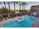 The community pool and lounge area features palm trees offering an ideal spot for relaxation and leisure at 4909 N Woodmere Fairway -- # 1004, Scottsdale, AZ 85251