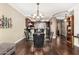 Elegant dining area featuring a glass table and comfortable chairs, adjacent to a modern kitchen with stainless steel appliances at 4909 N Woodmere Fairway -- # 1004, Scottsdale, AZ 85251