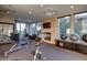 Bright exercise room with various workout machines, weights, and a fireplace at 4909 N Woodmere Fairway -- # 1004, Scottsdale, AZ 85251