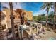 The home features covered outdoor kitchen, lounge chairs and several cabanas by the community pool at 4909 N Woodmere Fairway -- # 1004, Scottsdale, AZ 85251