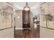 Inviting home foyer with dark wood flooring, neutral walls, art and stylish decor at 4909 N Woodmere Fairway -- # 1004, Scottsdale, AZ 85251