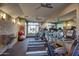 Well-lit gym featuring multiple treadmills, exercise equipment, and mirrored walls at 4909 N Woodmere Fairway -- # 1004, Scottsdale, AZ 85251
