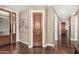 Beautiful hallway with wood floors, neutral walls, and wood doors at 4909 N Woodmere Fairway -- # 1004, Scottsdale, AZ 85251