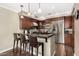 Well-equipped kitchen featuring a breakfast bar with seating, stainless steel appliances, and dark wood cabinetry for storage at 4909 N Woodmere Fairway -- # 1004, Scottsdale, AZ 85251