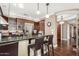 Modern kitchen with dark wood cabinetry, granite countertops, and stainless steel appliances, perfect for cooking and entertaining at 4909 N Woodmere Fairway -- # 1004, Scottsdale, AZ 85251