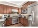 Well-maintained kitchen with stainless steel appliances, granite countertops, and dark wood cabinets, perfect for culinary enthusiasts at 4909 N Woodmere Fairway -- # 1004, Scottsdale, AZ 85251