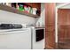 Laundry room showcases new washer and dryer plus custom cabinets for storage and organization at 4909 N Woodmere Fairway -- # 1004, Scottsdale, AZ 85251