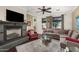Cozy living room with a fireplace, large windows, dark wood flooring, and comfortable seating at 4909 N Woodmere Fairway -- # 1004, Scottsdale, AZ 85251