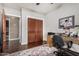 Well-lit office featuring a desk, chair, hard wood floors, and a storage closet at 4909 N Woodmere Fairway -- # 1004, Scottsdale, AZ 85251