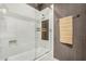 Bathroom featuring a tiled shower with seamless glass door and convenient built-in niche at 4909 N Woodmere Fairway -- # 1004, Scottsdale, AZ 85251