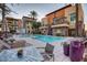 Exterior view of a luxury apartment building with a swimming pool and plenty of outdoor furniture at 4909 N Woodmere Fairway -- # 1004, Scottsdale, AZ 85251