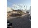 Backyard with gravel, incomplete wood construction and various debris at 530 S Alma School Rd # 75, Mesa, AZ 85210