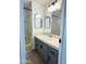 View of bathroom with gray vanity, white countertop, and shower and tub in the background at 530 S Alma School Rd # 75, Mesa, AZ 85210