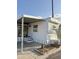 Exterior of mobile home with carport, decorative window feature and desert landscaping at 530 S Alma School Rd # 75, Mesa, AZ 85210