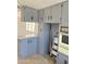 A view of the kitchen cabinets, vintage oven, and dining bar with a ladder to access the top shelves at 530 S Alma School Rd # 75, Mesa, AZ 85210