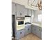 View of the kitchen features including the cooktop, vintage oven, overhead vent, and painted cabinets at 530 S Alma School Rd # 75, Mesa, AZ 85210