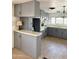 A view of the kitchen with the vintage oven, painted cabinets, and dining bar with countertop lamp at 530 S Alma School Rd # 75, Mesa, AZ 85210