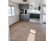Living room with carpet, gray kitchen, and window to outside at 530 S Alma School Rd # 75, Mesa, AZ 85210