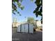 Metal storage shed surrounded by gravel landscaping with some sparse foliage at 530 S Alma School Rd # 75, Mesa, AZ 85210