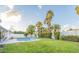 Backyard featuring a well-maintained lawn, privacy fence, mature landscaping, and a sparkling pool at 5324 E Hillery Dr, Scottsdale, AZ 85254