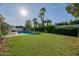The home has a sparkling pool and lush landscaping at 5324 E Hillery Dr, Scottsdale, AZ 85254